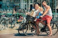 Parents on bikes at the streets of Amsterdam Royalty Free Stock Photo