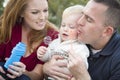 Parents Blowing Bubbles with Child Boy in Park Royalty Free Stock Photo