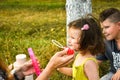 Parents blowing soap bubbles to child. Family love first. Family activity leisure outdoor in autumn park. Mother, father and two Royalty Free Stock Photo