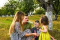 Parents blowing soap bubbles to child. Family love first. Family activity leisure outdoor in autumn park. Mother, father