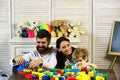 Parents and boy with smiling faces make brick constructions Royalty Free Stock Photo