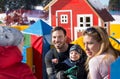 Parents with boys making snowman on mountain