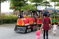 Parents bring the child to sit on a large toy train