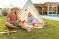 Parents camping in the backyard with their baby boy Royalty Free Stock Photo