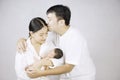 Parents carrying baby. portrait of young family with little son. selective focus of of happy young father kiss mother and hugging Royalty Free Stock Photo