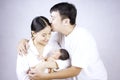 Parents carrying baby. portrait of young family with little son. selective focus of of happy young father kiss mother and hugging Royalty Free Stock Photo