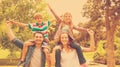 Parents carrying kids on shoulders at park Royalty Free Stock Photo