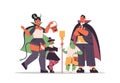 Parents and cchildren in different costumes standing together happy halloween party celebration concept