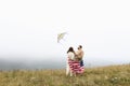 parents and child with American flag are playing with a colorful kite. mother, father and their little daughter Royalty Free Stock Photo