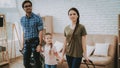 Parents and Child Arrived in New Bright Apartment. Royalty Free Stock Photo