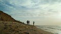 Parents child enjoy sea waves on sand beach. Family loving ocean coast vacation. Royalty Free Stock Photo