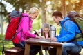 Parents and child look map in the forest