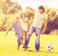 Parents with child playing with soccer ball Royalty Free Stock Photo