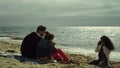 Parents child posing beach sea. Young family taking camera photos by shiny ocean Royalty Free Stock Photo