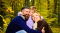 Parents and child together in park on sunny autumn day. Happy family mother and father huggs little son. Happy couple Royalty Free Stock Photo