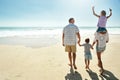 Parents, children and beach or happy summer travel sea vacation, ocean sunshine or siblings.. Man, woman and kid piggy Royalty Free Stock Photo