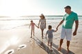 Parents, children and beach or holding hands for happy summer or travel, ocean sunshine or sibling development. Man Royalty Free Stock Photo