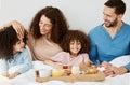 Parents, children and breakfast in bed, morning or excited for love, bonding or care on holiday. Mother, father and kids Royalty Free Stock Photo