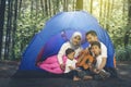 Parents and children camping in the forest together