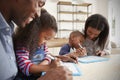 Parents And Children Drawing On Whiteboards At Table Royalty Free Stock Photo