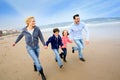 Family running on the beach Royalty Free Stock Photo