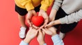 Parents and children hold a red heart in their hands, close-up. Family Day. Generative Ai. Royalty Free Stock Photo
