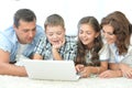 parents with children with laptops are lying on the back Royalty Free Stock Photo