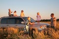 Parents and children on offroad car on wheaten fie