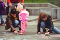 Parents and children paint on asphalt