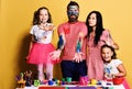 Parents and children painted all over with gouache on yellow Royalty Free Stock Photo