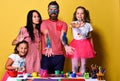 Parents and children painted all over with gouache on yellow Royalty Free Stock Photo