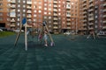 Parents with children play on the playground in the common courtyard of a residential apartment building on a summer day Royalty Free Stock Photo