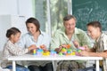 Parents and children playing with colorful plastic blocks at classroom