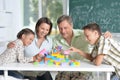 Parents and children playing with colorful plastic blocks at classroom