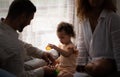 Parents and children relax in the living room of the house. Watch baby happily play Royalty Free Stock Photo