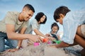 Parents, children and sandcastle at beach, bucket and digging for bonding, outdoor and vacation in summer. Mother Royalty Free Stock Photo