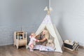 Parents with children in a teepee