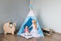 Parents with children in a teepee