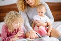 Parents and Children Together. woman showing pictures to her kids Royalty Free Stock Photo