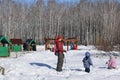 Parents with children are walking in the winter park.