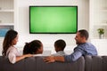 Parents and children watching TV, looking at each other Royalty Free Stock Photo