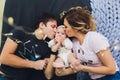 Parents cuddling baby in bed at home. Mom, dad and baby. Happy family concept. Royalty Free Stock Photo