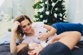 Parents cuddling baby in bed at home. Mom, dad and baby. Happy family concept. Royalty Free Stock Photo