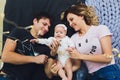 Parents cuddling baby in bed at home. Mom, dad and baby. Happy family concept. Royalty Free Stock Photo