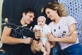 Parents cuddling baby in bed at home. Mom, dad and baby. Happy family concept. Royalty Free Stock Photo