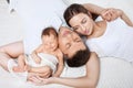 Parents cuddling newborn baby in bed at home. Mom, dad and baby. Royalty Free Stock Photo