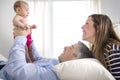 Parents Cuddling Newborn Baby In Bed At Home Royalty Free Stock Photo