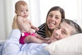 Parents Cuddling Newborn Baby In Bed At Home Royalty Free Stock Photo