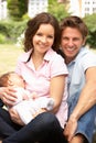 Parents Cuddling Newborn Baby Boy Outdoors At Home Royalty Free Stock Photo