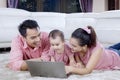 Parents with cute baby using a laptop